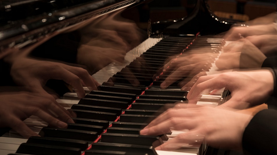 close up of a boys hand playing the guitar