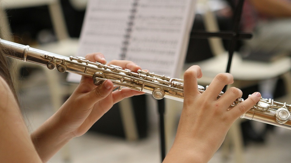close up of a boys hand playing the guitar