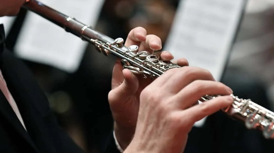 close up of a boys hand playing the guitar